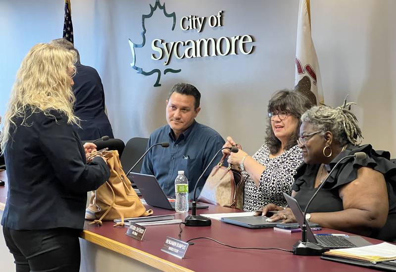 Executive Director of Sycamore Chamber of Commerce Rose Treml talks with 3rd Ward Sycamore Alderpersons Jeff Fischer and Nancy Copple, as well as 4th Ward Alderperson Virginia Sherrod, after Sycamore City Council voted to award the chamber a $40,000 donation during the July 17, 2023 City Council meeting