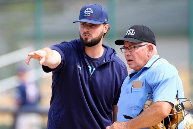 Haydon Price, a former star player and graduate of Marquette Academy, checks in with an umpire as manager of the Green Bay Blue Ribbons.