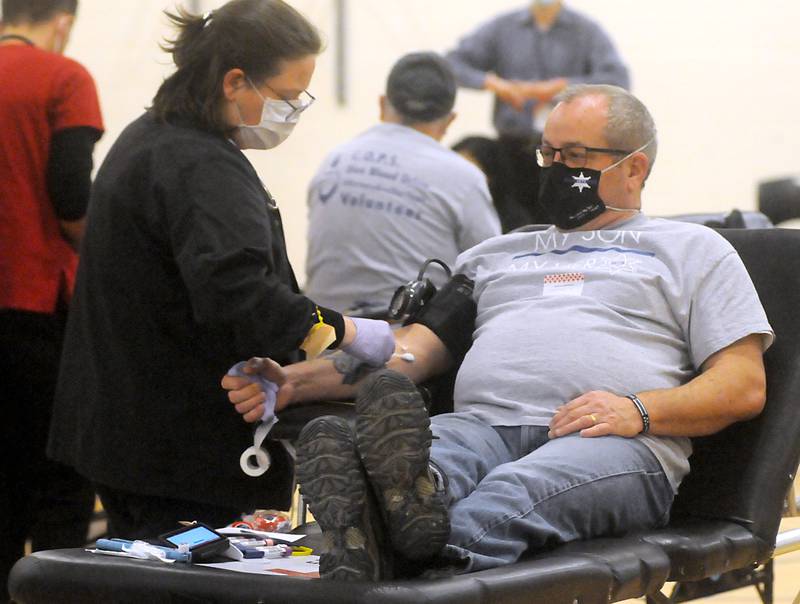 Howard Keltner, the father of Jacob Keltner, donates blood during the third annual Jake Keltner Memorial Blue Blood Drive on Law Enforcement Appreciation Day, Sunday, Jan. 9, 2022, at the Sage YMCA. McHenry County sheriff's Deputy Jacob Keltner was killed in the line of duty serving an arrest warrant in March 2019 in Rockford. All 230 appointments to donate blood were filled this year.