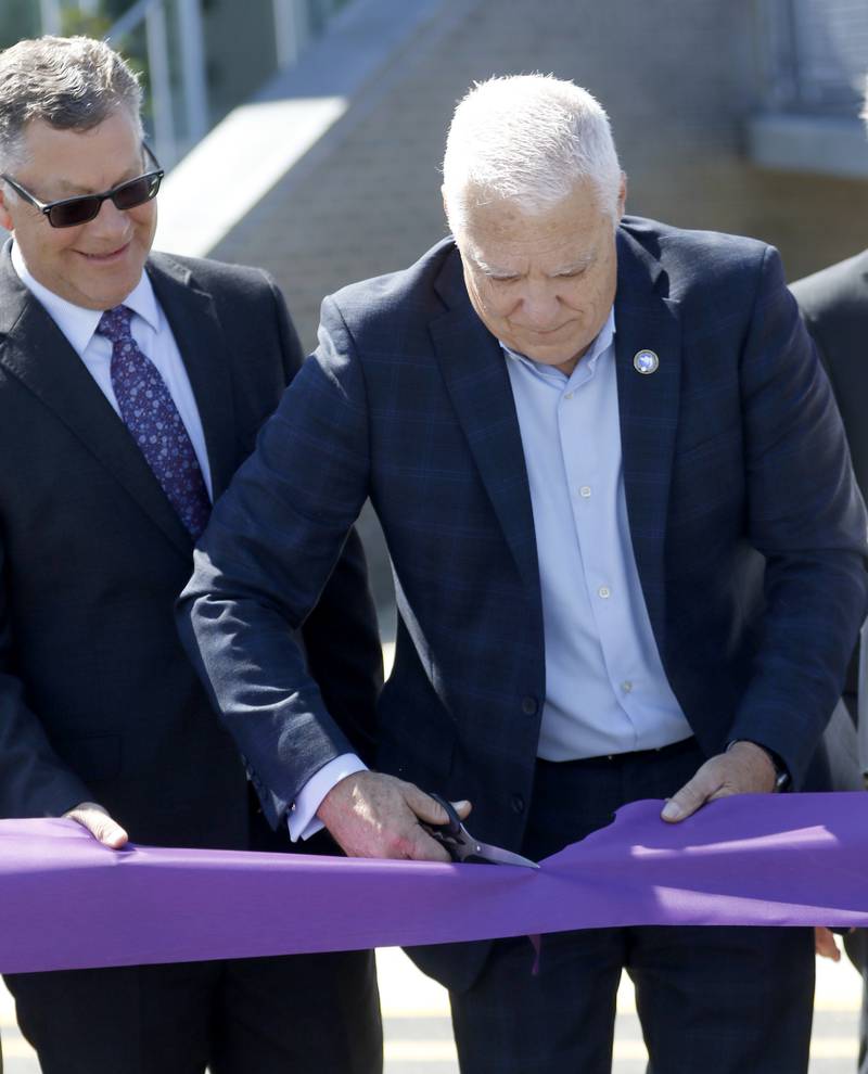 Michael Buehler,  Chairman of the McHenry County Board watches as Dr. Clint Gabbard, President of McHenry County College, cuts the ribbon during the opening ceremony for the Foglia Center for Advanced Technology and Innovation on Tuesday, Sept. 3, 2024, at McHenry County College.