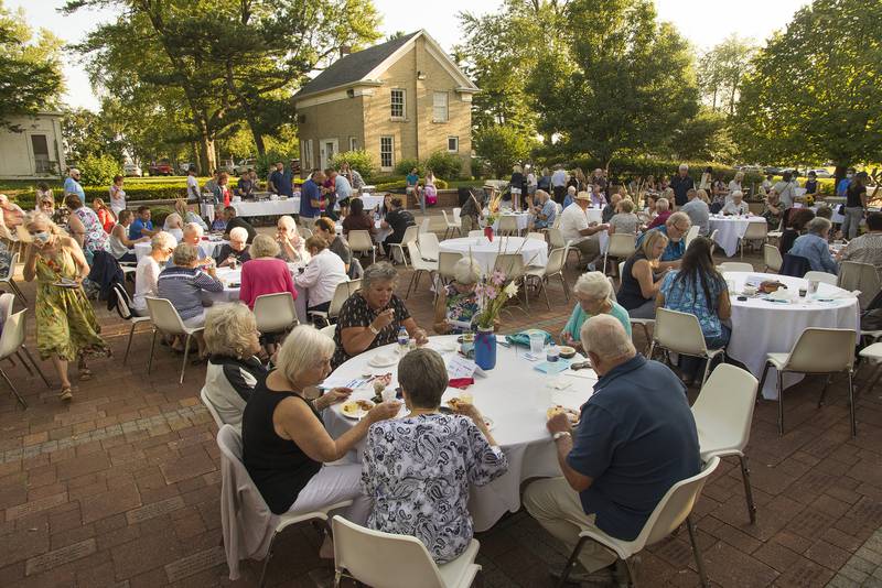 Tasters fill outside tables during the 50 Men Who Cook fundraiser benefitting CASA DeKalb County in this Shaw Local file photo on Saturday Aug. 14, 2021.