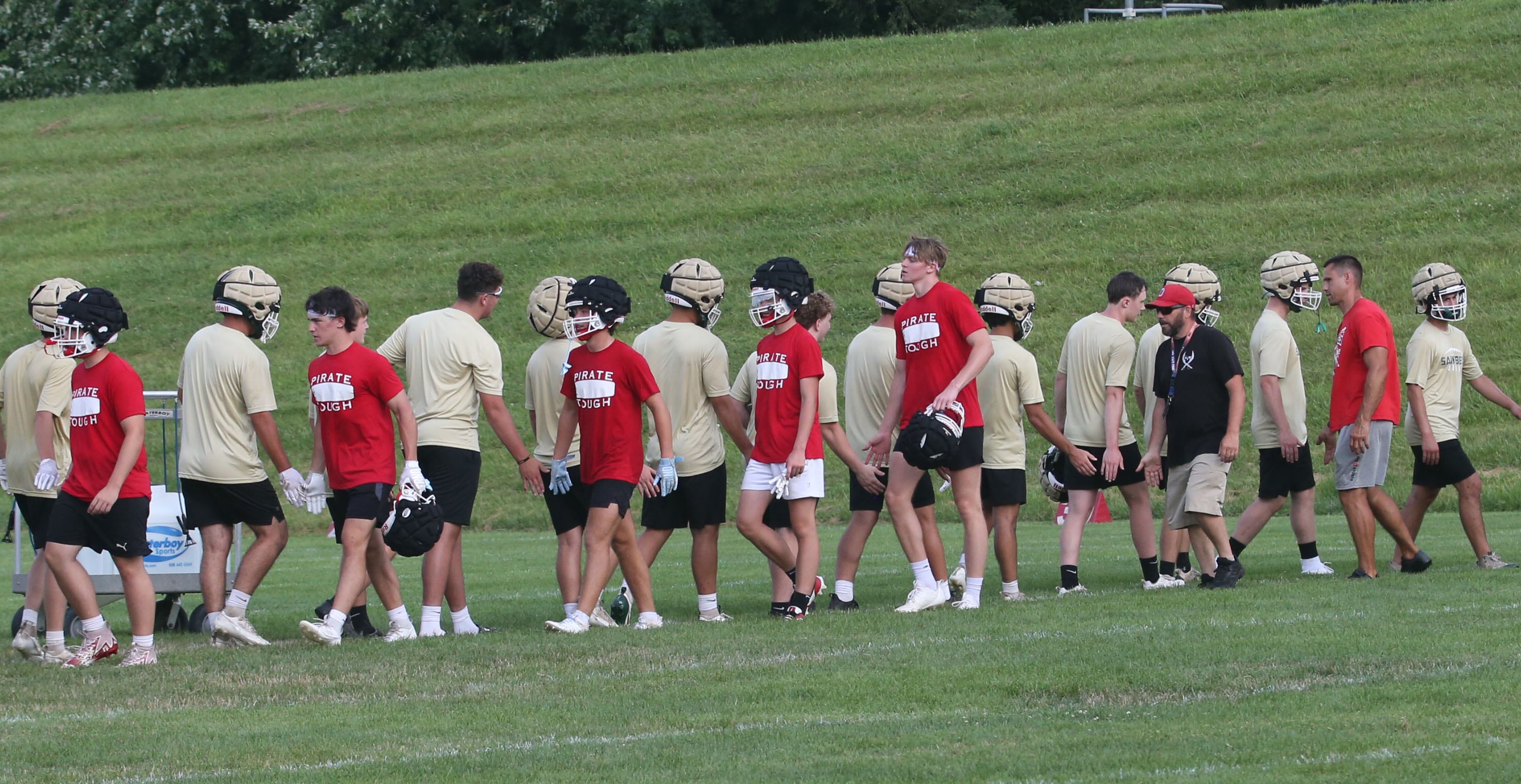 Members of the Ottawa and St. Bede football teams shake hands following their 7-on-7 practice on Wednesday, July 24, 2024 at Ottawa High School.