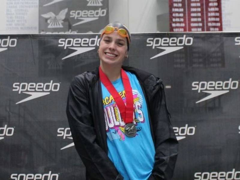 Mendota senior Bridget McGann stands on the podium after placing second in the 100-meter breaststroke at the National Club Swimming Association Summer Championships with a time of 1:09.81, which qualified her to compete in the 2024 USA Swimming Olympic Trials in June in Indianapolis.