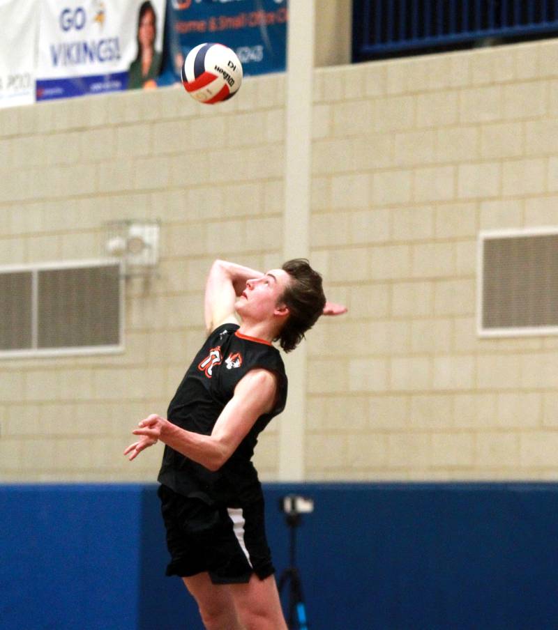 Wheaton Warrenville South’s Simon Bratt serves the ball during a game at Geneva on Tuesday, April 2, 2024.