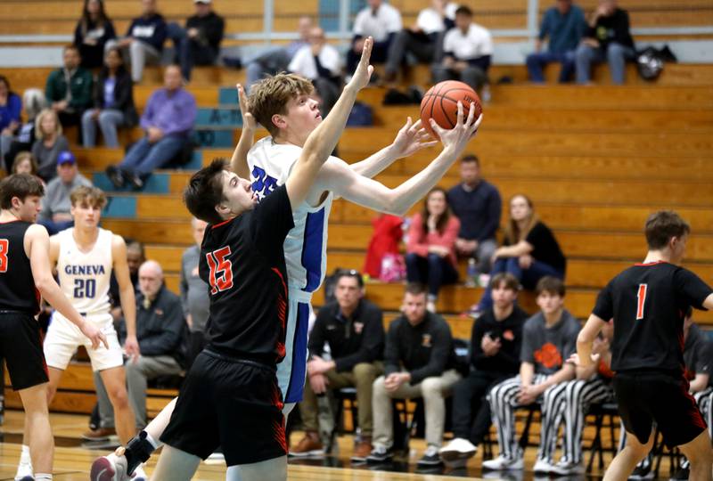 Geneva’s Hudson Kirby goes up for a shot under the defense of Wheaton Warrenville South’s Joe Preede during a Class 4A Willowbrook Regional semifinal game on Wednesday, Feb. 21, 2024.