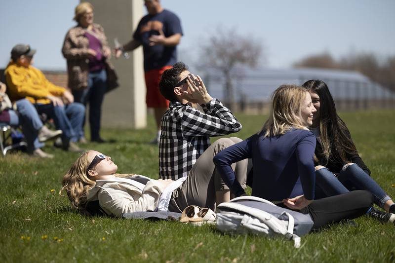 Emily Roth (left), Diego Peavey, Jasmine Mills and Gyneya Roman find a spot along the east lawn at Sauk Valley Community College Monday, April 8, 2024 to view the solar eclipse.