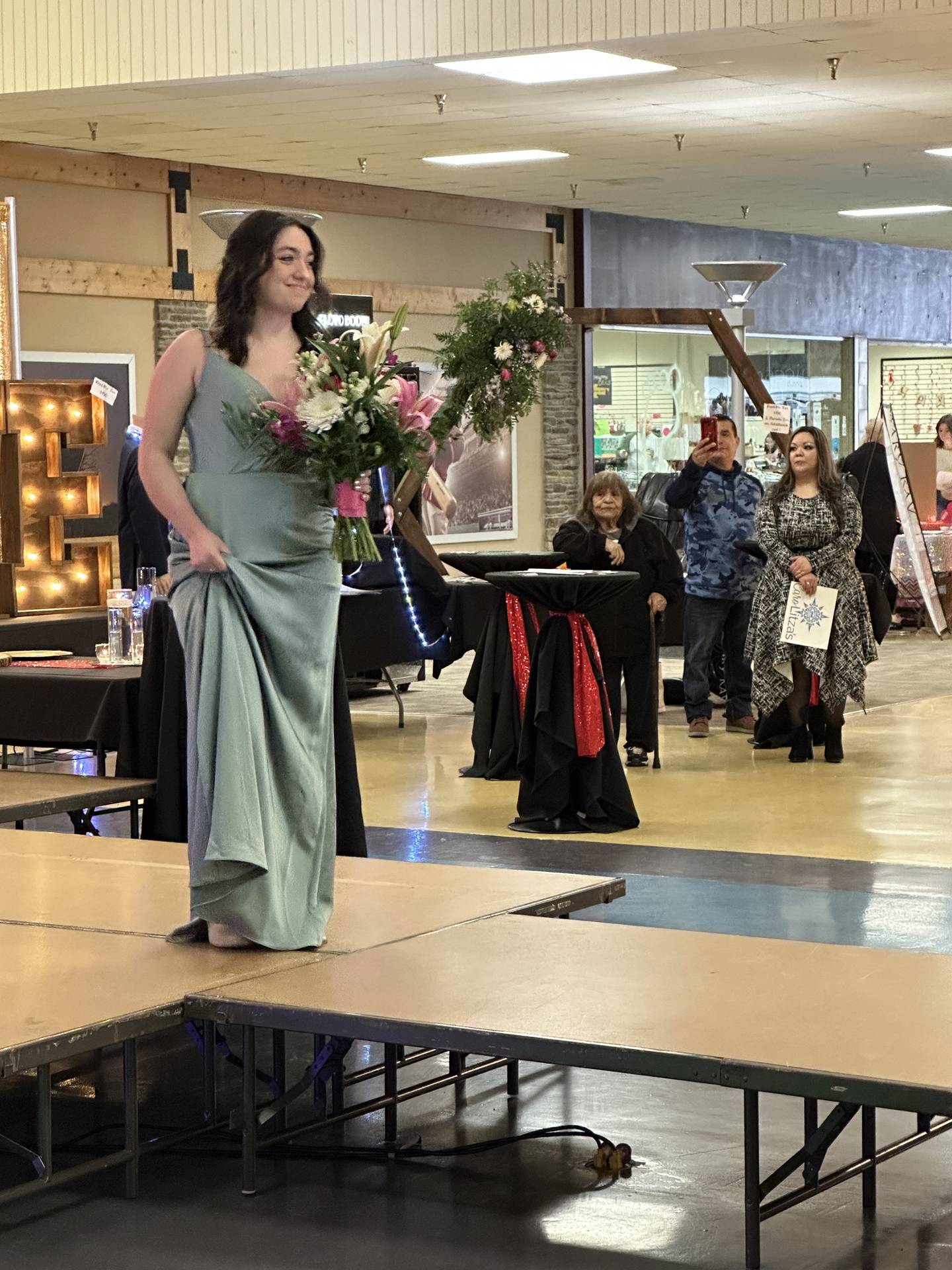 Autry Prior appears on the runway in bridesmaid wear on Sunday, Feb. 5, 2023, at Northland Mall in Sterling during the Sauk Valley Bridal Fair.