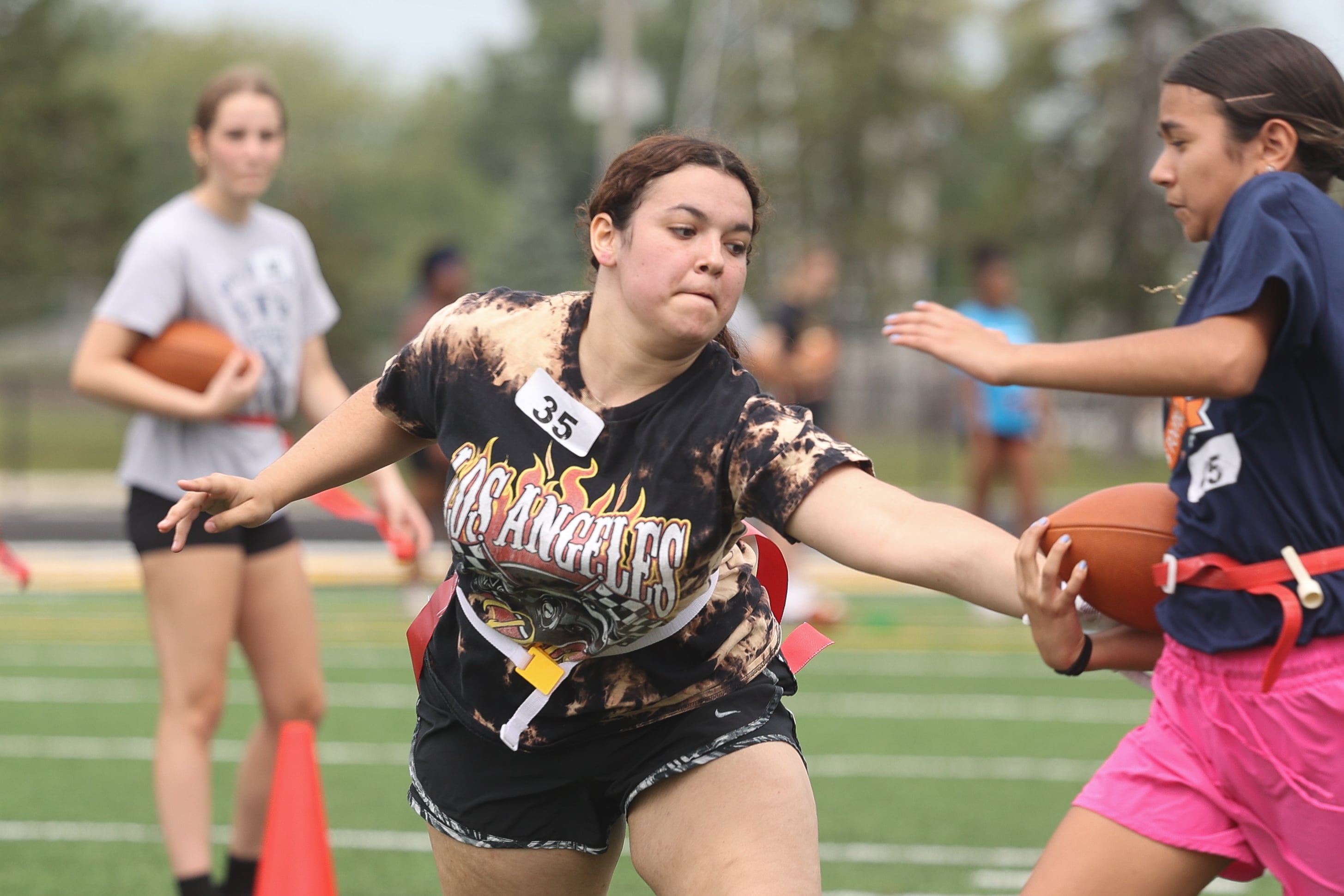 Maryana Sepulveda goes for the flag during Joliet West’s girls flag football tryouts on Monday, Aug. 12, 2024 at Joliet West High School.