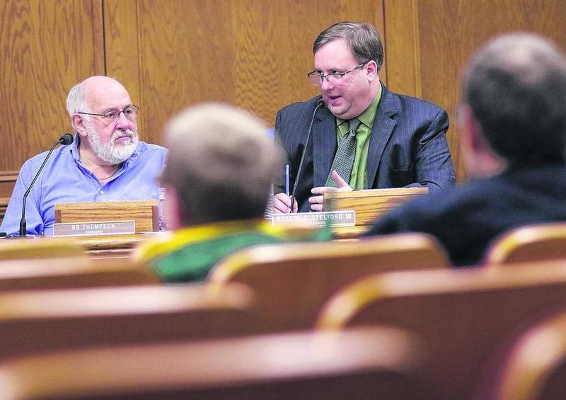 Woodstock Councilman RB Thompson (back left) and Woodstock City Manager Roscoe Stelford attend to the agenda during a council meeting Tuesday in the City Council Chambers at City Hall.