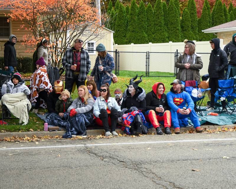 The Cifonie family dresses up as superhero themed outfits as they watch the Sycamore Pumpkin Festival parade held in downtown Sycamore on sunday Oct. 29, 2023.