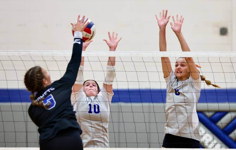 Newman's Lucy Oetting takes a shot at Princeton's Makayla Hecht and Keighley Davis Tuesday night at Prouty Gym.