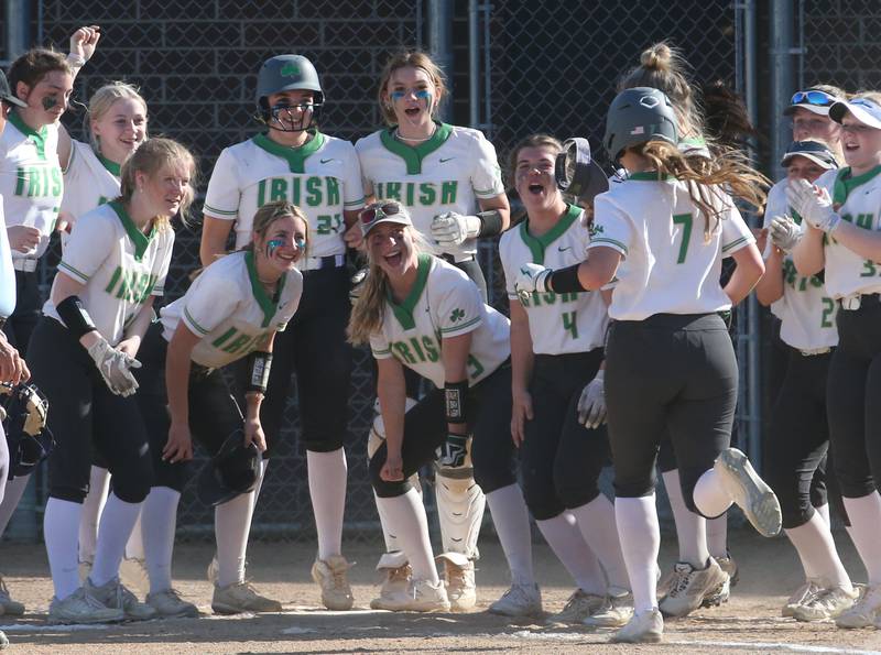 Seneca's Audry McNabb runs to home after hitting a homerun against Putnam County while being greeted by her teammates on Thursday, April 13, 2023 at Seneca High School.