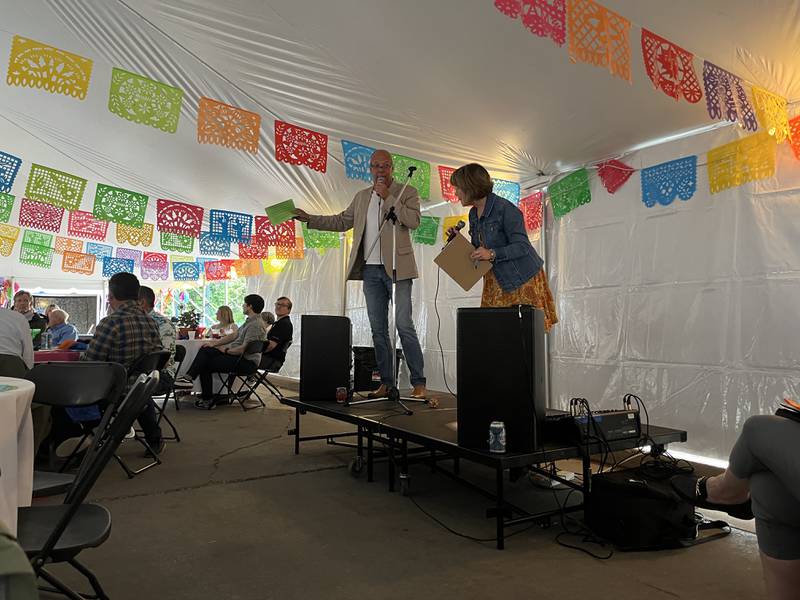 Debbie Nagy (right), a member of Discover Dixon’s beautification committee, and Mike Venier (left), Dixon city council member, led participants in the live auction of 33 items during the Rock River Garden Club's fundraiser on Saturday, June 8.