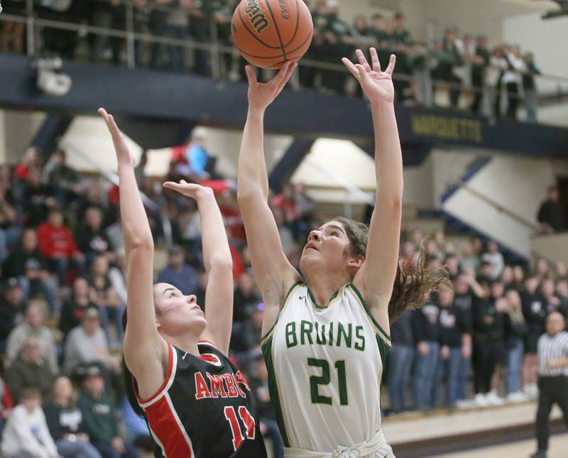 St. Bede's Lily Bosnich lets go of a shot over Amboy's Tyrah Vaessen during the Class 1A Regional final game on Friday, Feb. 16, 2024 at Marquette High School.
