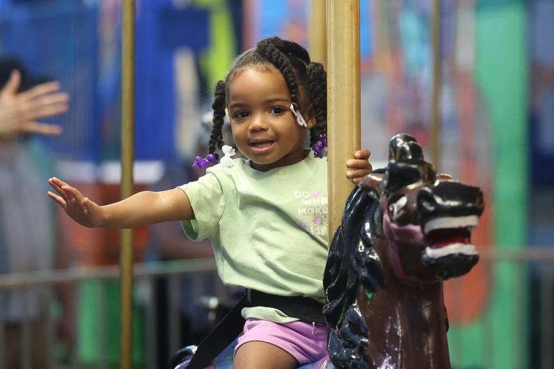 Chai Smith-Shell rides the Merry-Go-Round at the Taste of Joliet on Saturday, June 22, 2024 at Joliet Memorial Stadium.