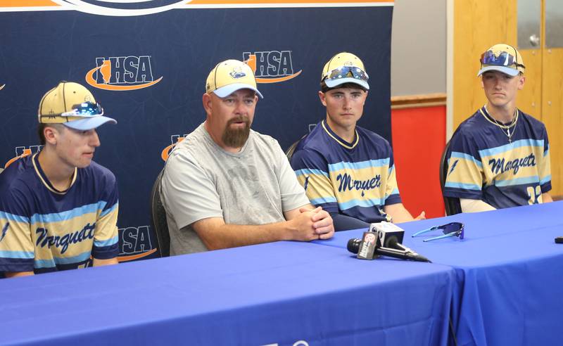 Marquette head coach Todd Hopkins talks during the press conference with his teammates Alec Novotney, Anthony Couch and Griffin Dobberstein after defeating Routt in the Class 1A semifinal game on Friday, May 31, 2024 at Dozer Park in Peoria.