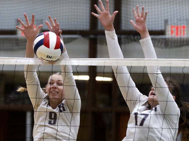 Prairie Ridge's Amelia Bowen and Prairie Ridge's Mackenzie Schmidt block a Belvidere North hit during the Class 3A Woodstock North Sectional finals volleyball match on Wednesday, Nov. 1, 2023, at Woodstock North High School.