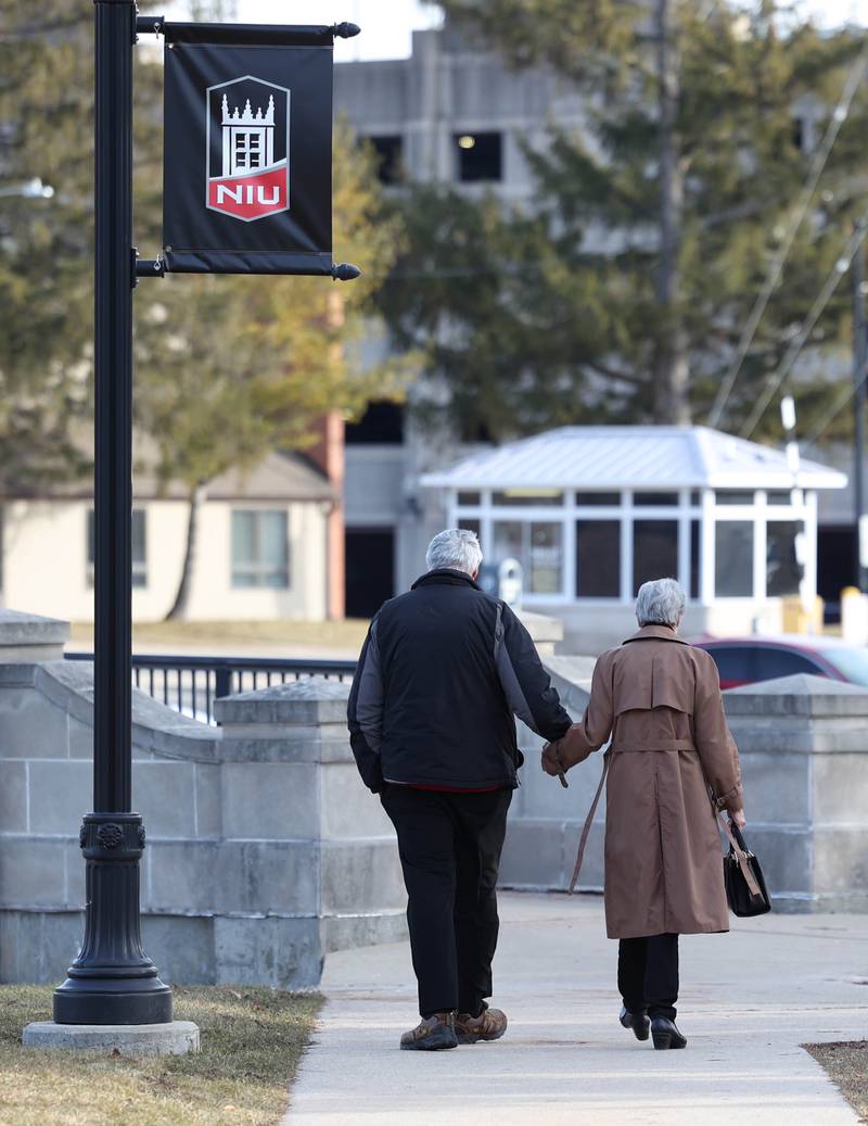 Linda Greer, mother of shooting victim Dan Parmenter, and her husband Robert Greer, leave campus Wednesday, Feb. 14, 2024, after a ceremony in the Peaceful Reflection Garden near Cole Hall at Northern Illinois University honoring the victims of the 2008 shooting on campus in DeKalb. Wednesday marked 16 years since the deadly shooting took place at NIU which took the lives of five people.