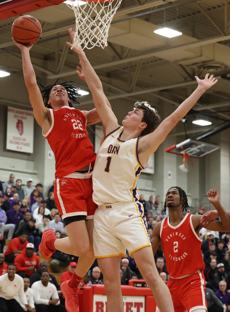 Homewood-Flossmoor’s Gakobie McNeal (22) goes to the basket against Downers Grove North’s Jake Riemer (1) during the When Sides Collide Shootout on Saturday, Jan. 20, 2024 in Lisle, IL.