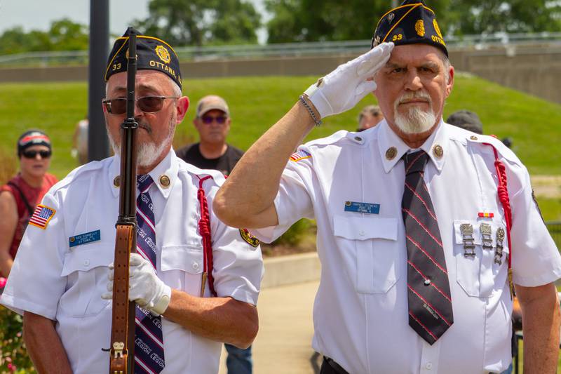 Veterans salute while "America the Beautiful" is performed on Saturday, June 15, 2024, during the Illinois Motorcycle Freedom Run at the Middle East Conflicts Wall in Marseilles.