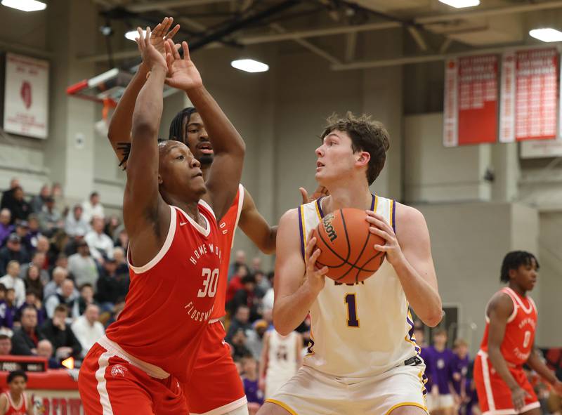 Downers Grove North’s Jake Riemer (1) goes up against Homewood-Flossmoor’s Carson Brownfield (30) during the When Sides Collide Shootout on Saturday, Jan. 20, 2024 in Lisle, IL.