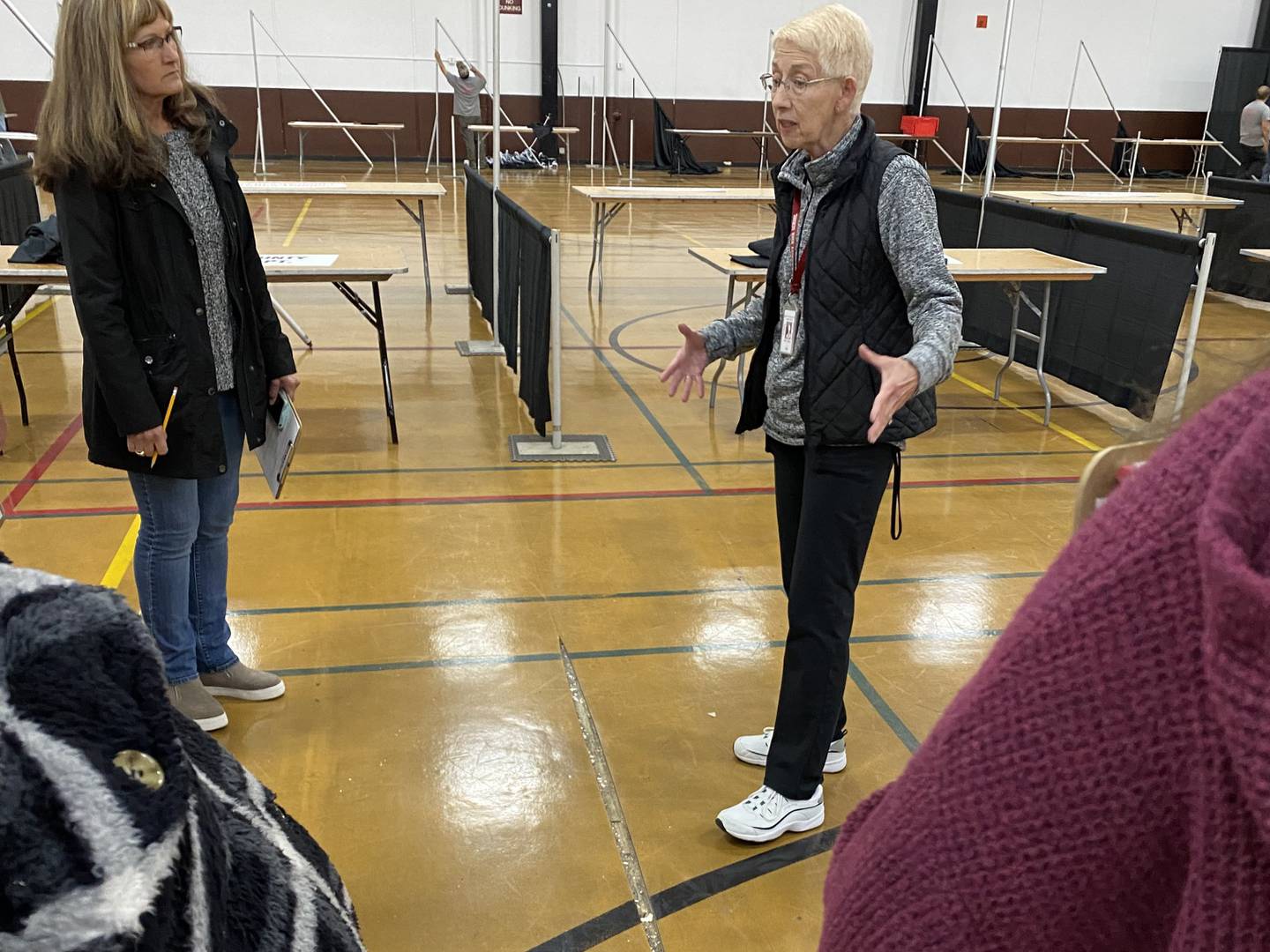 Joanne Engle explains the state of the field house at Morris Community High School, where the gym floor has holes in it.