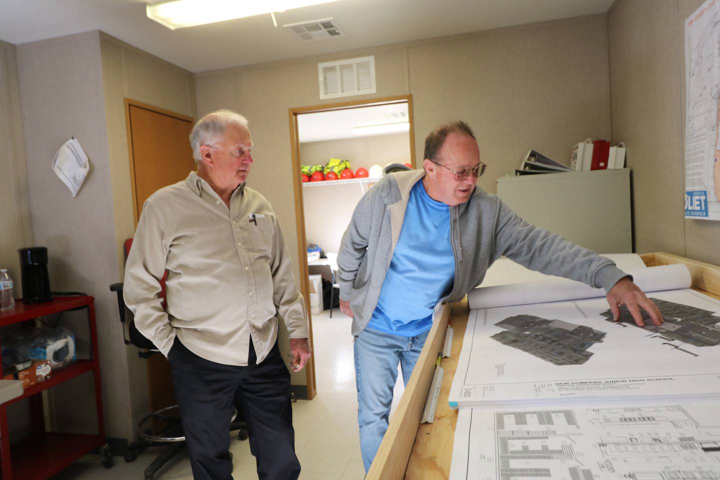 Bob DiLorenzo looks over the construction plans of the new Gompers Junior High with Chuck Bernhardt, the construction superintendent from Nicholas & Associates, Inc.