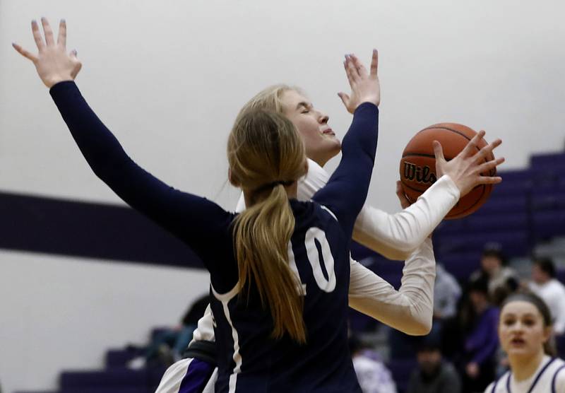 Hampshire's Avery Cartee shoots the ball while she is defended by Cary-Grove's Alivia Nielsen during a Fox Valley Conference girls basketball game Friday, Jan. 26, 2024, at Hampshire High School.