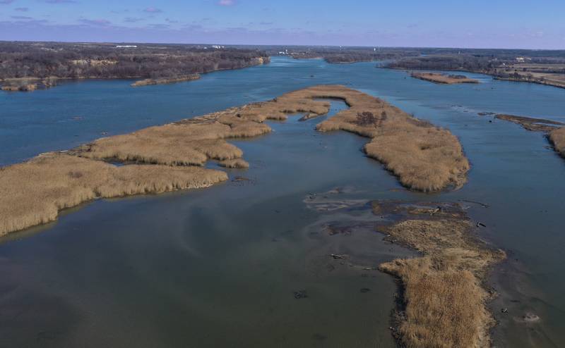 An aerial view of Delbridge Island looking east toward Ottawa on Tuesday, Feb. 13, 2024 near Starved Rock State Park. The Starved Rock Breakwater project is a habitat restoration effort designed to restore submerged aquatic vegetation in the Illinois River, Starved Rock Pool. It will increase the amount and quality of resting and feeding habitat for migratory waterfowl and improve spawning and nursery habitat for native fish.
Construction of the breakwater will involve placement of riprap along northern edge of the former Delbridge Island, adjacent to the navigation channel between River Mile 233 and 234. The breakwater structure will be approximately 6,100 feet long and constructed to a design elevation 461.85 feet, providing adequate protection to allow for submerged aquatic vegetation growth.
The estimated total cost of this project is between $5 and $10 million.