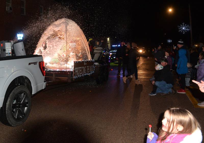 Bryan Coffman, 4, of Erie, watches as the Hanford Insurance float provides snow during the Erie Hometown Holidays Lighted Parade on Saturday, Dec. 2, 2023.