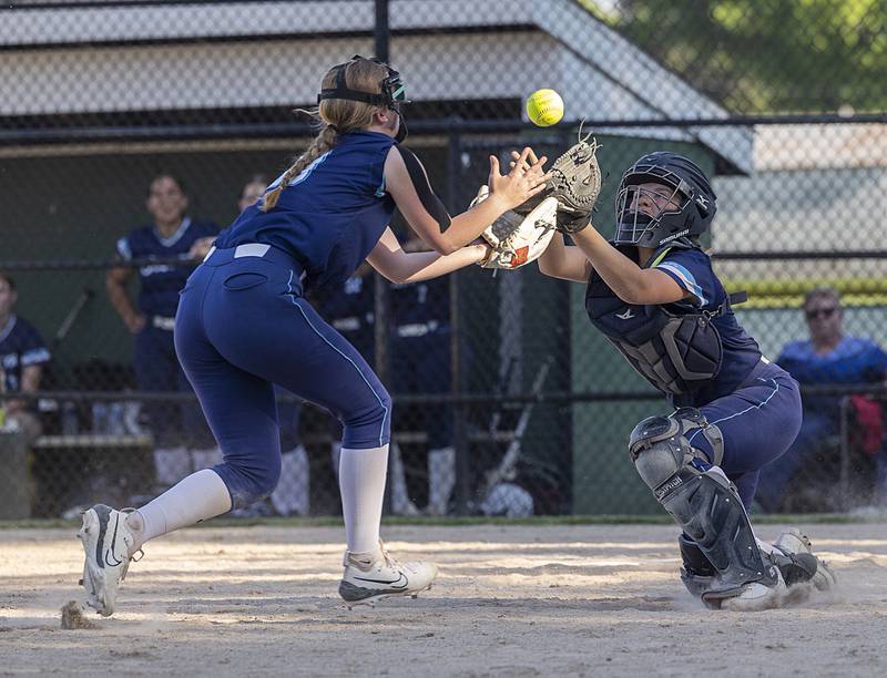 Bureau Valley catcher Emily Wright and Kadyn Haage collide on a pop up at the plate against Princeton Friday, May 17, 2024, at the Class 2A regional semifinals in Rock Falls. Wright caught the ball but lost her mitt in the arms of Haage. The ball trickled out for a foul.