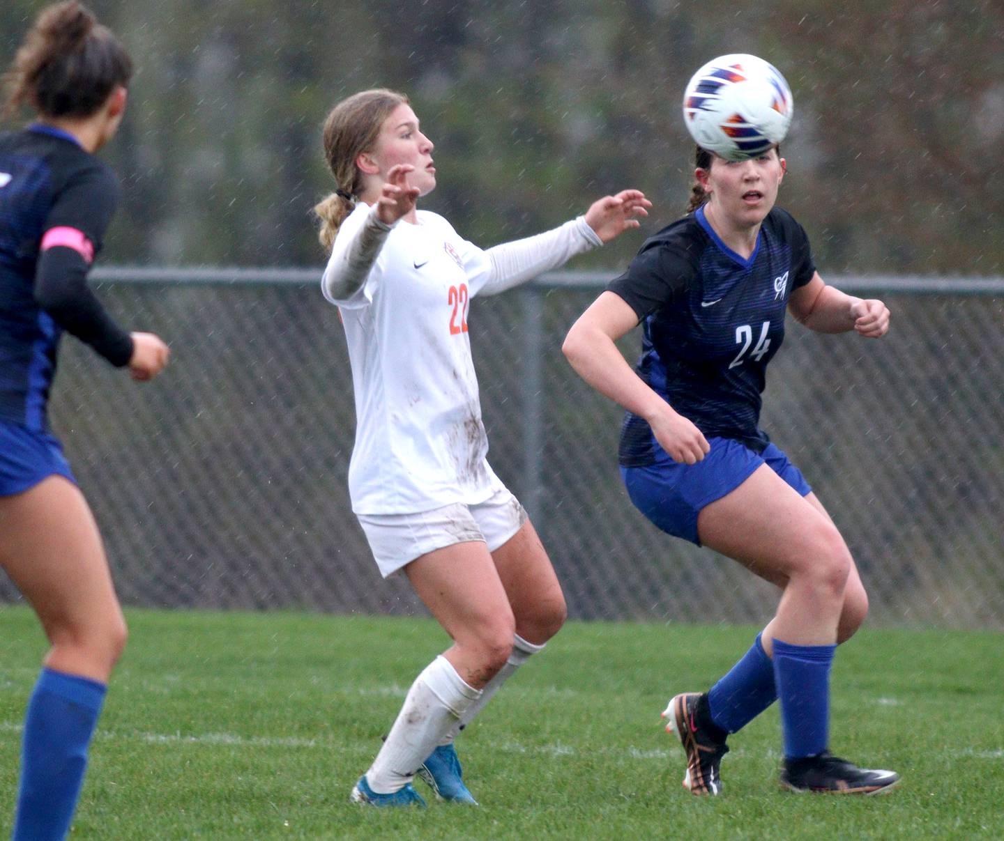 Burlington Central’s Alison Kowall, right, looks for the ball with Crystal Lake Central’s Olivia Anderson, center,  in varsity soccer at Burlington Thursday night.