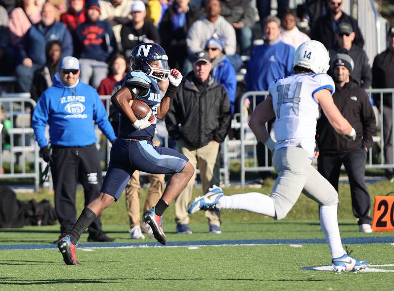 Nazareth's Lesroy Tittle (21) breaks free for a touchdown run against St. Francis during the boys varsity IHSA 5A semifinal between Nazareth Academy and St. Francis high school in La Grange Park, IL on Saturday, Nov. 18, 2023.