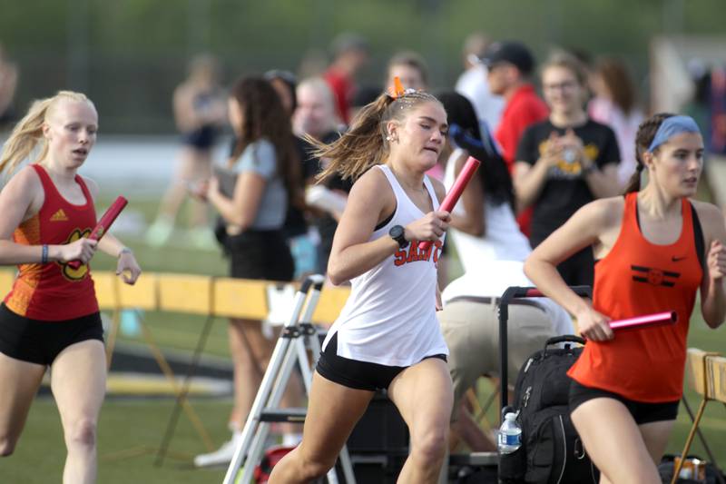 St. Charles East’s Marley Andelman (center) runs a leg of the 4 x 800-meter relay during the Class 3A Metea Valley girls track and field sectional on Thursday, May 11, 2023.