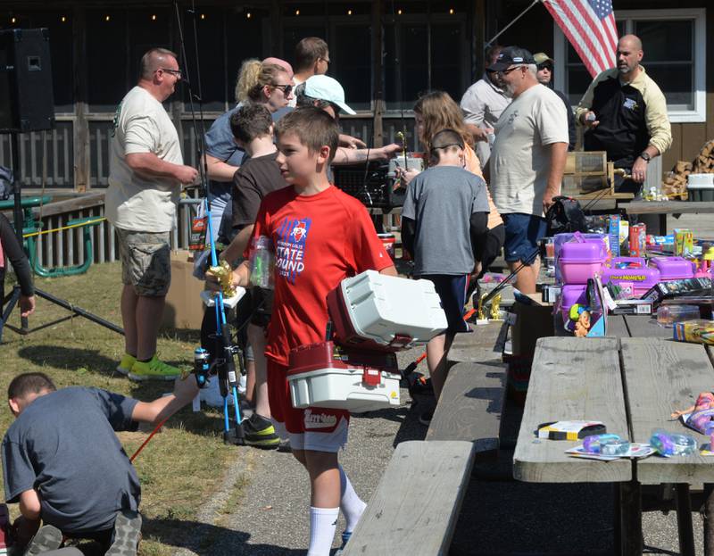 Euryah Wright, 12, of Morrison, carries some of the prizes he won at the Whiteside County Sheriff Office and Mounted Patrol's annual fishing derby at Morrison-Rockwood State Park in Morrison on Saturday, Sept. 9, 2023.