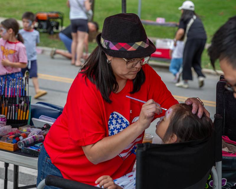 Pamela Hutcheson face paints at the Hinsdale 4th of July Family Celebration.  July 4th, 2024.