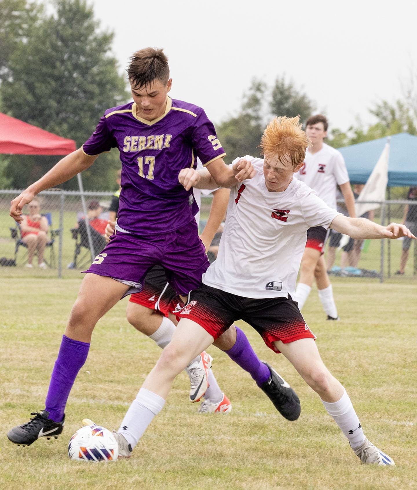 Indian Creek's Tyler Bogle (at right) gets a foot on the ball while the Serena's Beau Raikes fights for control in the opening game of the Serena Tournament on Saturday, Aug. 26, 2023.