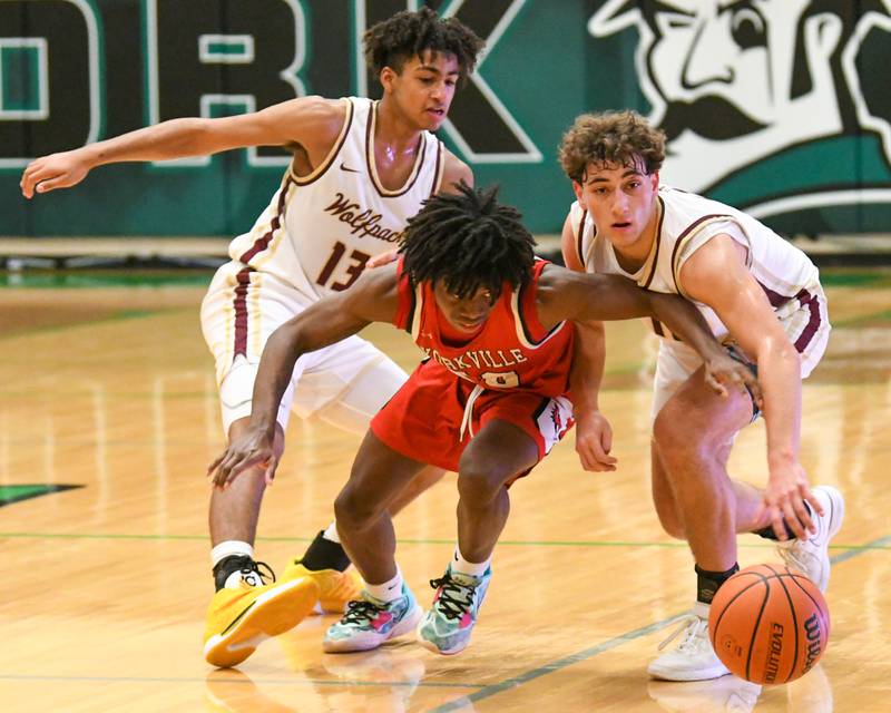Yorkville's Kaevian Johnson, center battles for the ball while being defended by St. Ignatius teammates Phoenix Gill, left, and St. Ignatius's Philip Erickson (11) in the second half of the game on Tuesday Dec. 26, 2023, during the Jack Tosh tournament held at York High School in Elmhurst.
