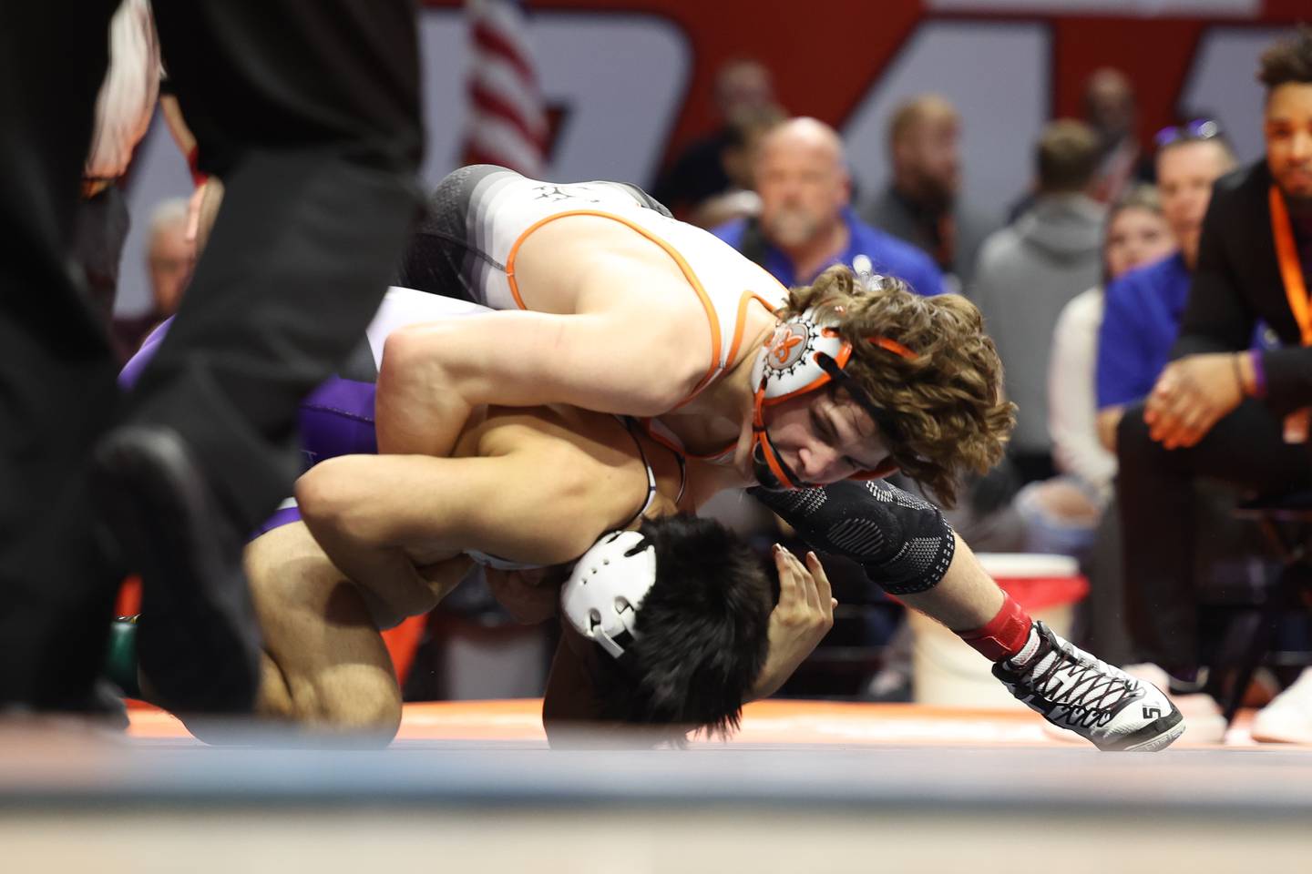 St. Charles East's Ben Davino works over Hononega’s Thomas Silva in the 132-pound Class 3A state championship match on Saturday, Feb. 17th, 2024 in Champaign.