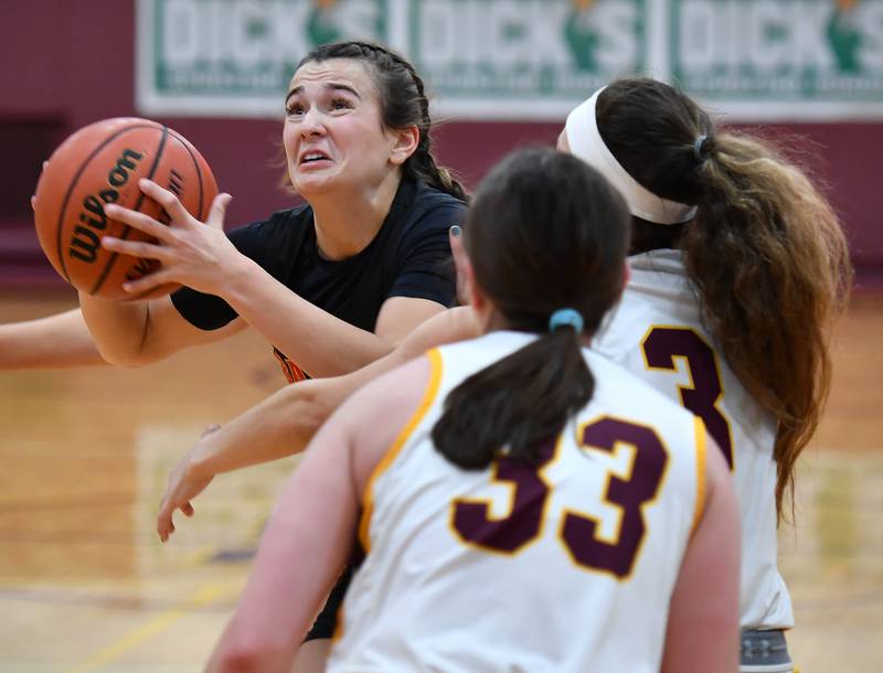 Batavia's Brooke Carlson (left) shoots under heavy pressure from Loyola defenders during a Coach Kipp Hoopsfest game on Jan. 13, 2024 at Montini Catholic High School in Lombard.