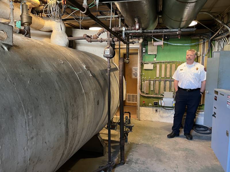 Sycamore Fire Chief Bart Gilmore looks at a 66-year-old boiler in the basement of Sycamore Fire Station 1 on June 9, 2023. Gilmore said the boiler broke down a couple of times this past winter -temperatures inside the stations living quarters got as low as 40 degrees.