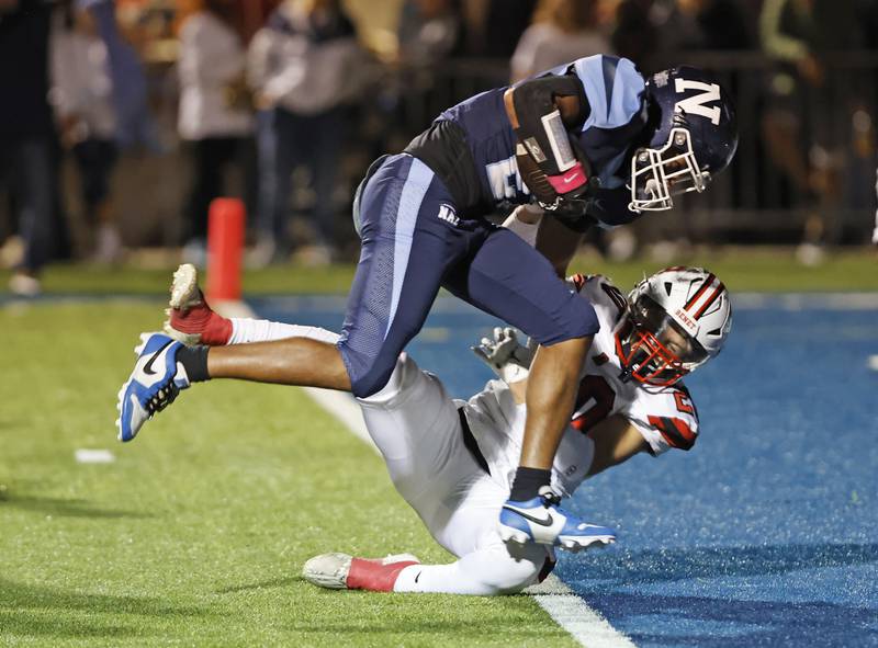 Nazareth's Charles Calhoun (27) breaks the goal line to score during the varsity football game between Benet and Nazareth academies on Friday, Oct. 18, 2024 in La Grange Park.