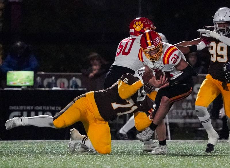 Batavia’s Ryan Boe (21) is hit in the backfield for a loss by Mt. Carmel's Tavon Rice (71) during a class 7A semifinal football playoff game at Mt. Carmel High School in Chicago on Saturday, Nov 18, 2023.