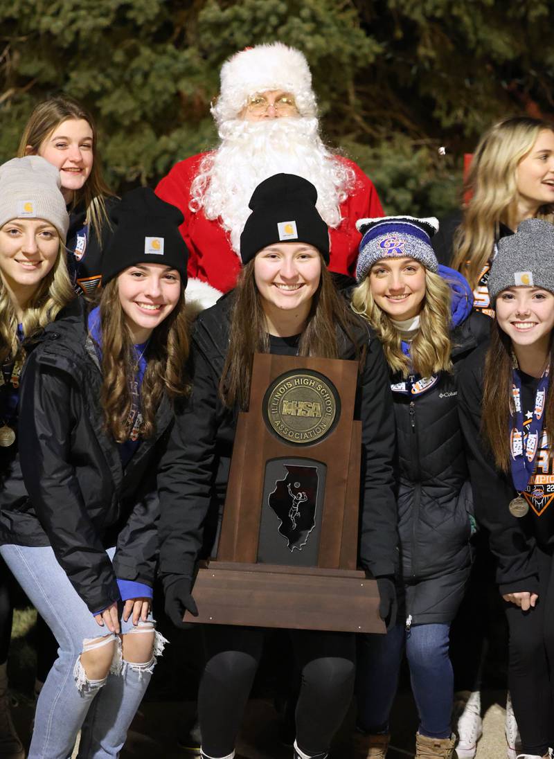 Members of the Genoa-Kingston volleyball team pose with Santa and the state championship trophy Friday, Dec. 2, 2022, during Celebrate the Season hosted by the Genoa Area Chamber of Commerce.