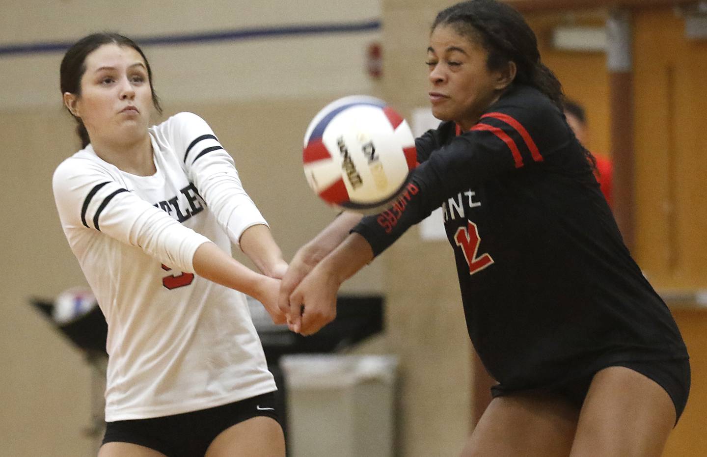 Huntley's Mari Rodriguez and Morgan Jones hit as they trie to pass the ball during a Fox Valley Conference volleyball match against Crystal Lake Central Tuesday, Aug. 22, 2023, at Huntley High School.