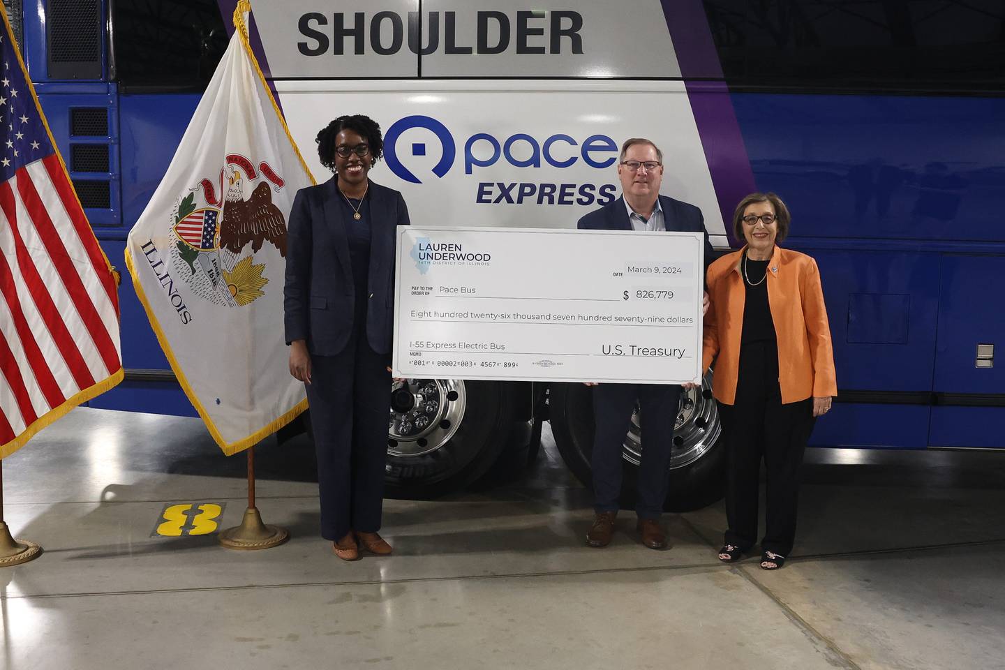 State Representative Lauren Underwood presents Pace Executive Director Melinda Metzger and Pace Chairman Rick Kwasneski a check for $826,779 for Pace’s expansion of electric buses at Pace’s bus depot on Monday July 1, 2024 in Plainfield.