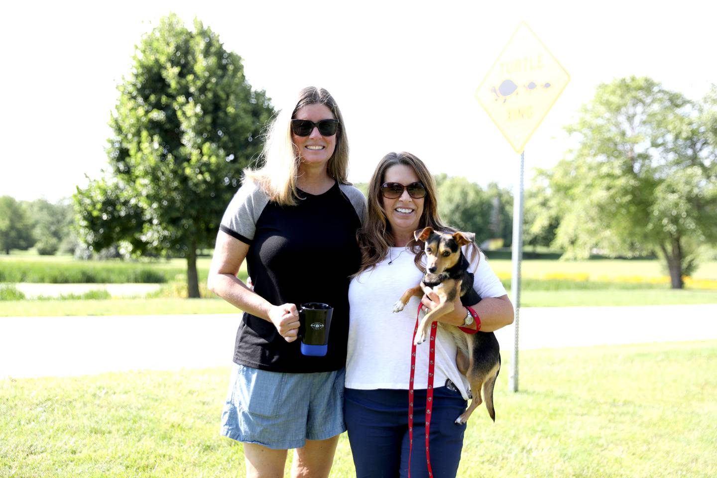 Cindy Braden (left) and Abby Drommerhausen were two of the Sunset Views community members in Lily Lake to fund Turtle Crossing signs. The signs were installed on Monday, July 8, 2024 after neighborhood families came together to fund the project in an effort to protect their neighborhood turtles from vehicle traffic.