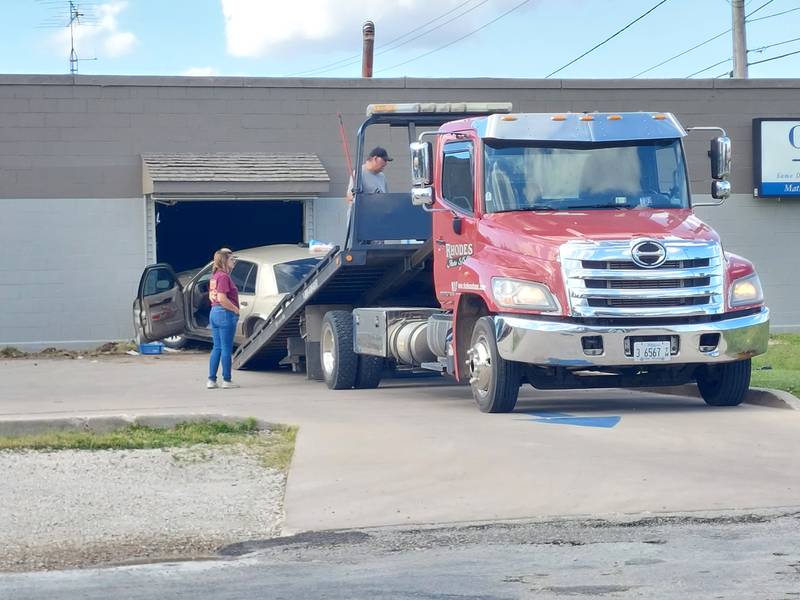 A car is towed Monday, May 27, 2024, after it crashed into Curly's Furniture in Streator.