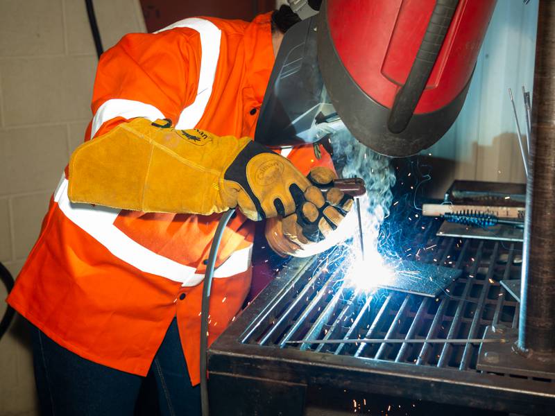 An Illinois Valley Community College student performs flat position stick metal arc welding.