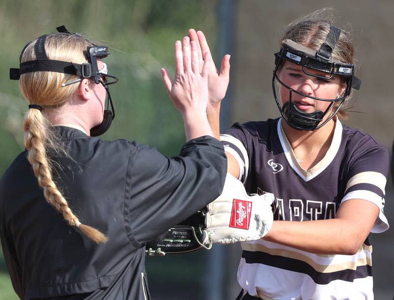 Sycamore's Addison Dierschow (right) gets a high-five from teammate Keera Trautvetter after recording an out during their game against Sterling Tuesday, May 14, 2024, at Sycamore High School.